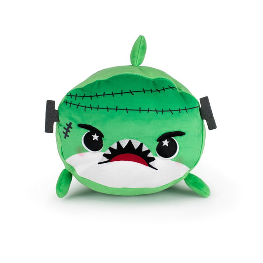Vic the Monster Shark is a round, green plushie with black stitched lines, angry eyes, a scar, sharp teeth, and small fins—combining the look of a shark with Frankenstein's monster.