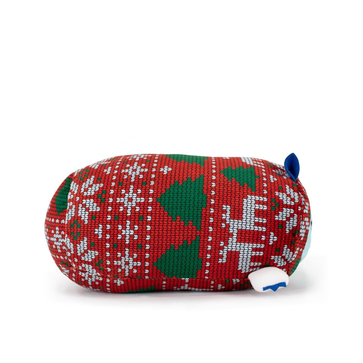 Artie the Yeti Slumber is a festive plush shaped like a rounded creature, wearing a red, green, and white holiday sweater with snowflakes, trees, and a reindeer. It has blue and white ears, a white tail, and is machine washable.