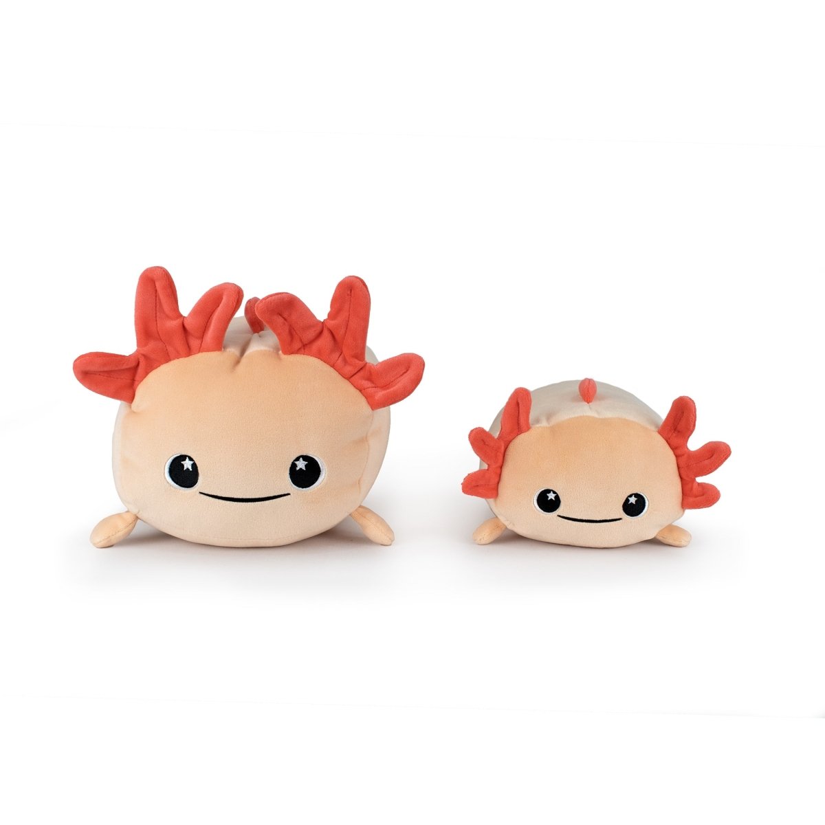 Two Pearl the Axolotl plushies with pink bodies, red feathery head frills, black eyes, and smiles sit side by side on a white background. One is larger than the other.