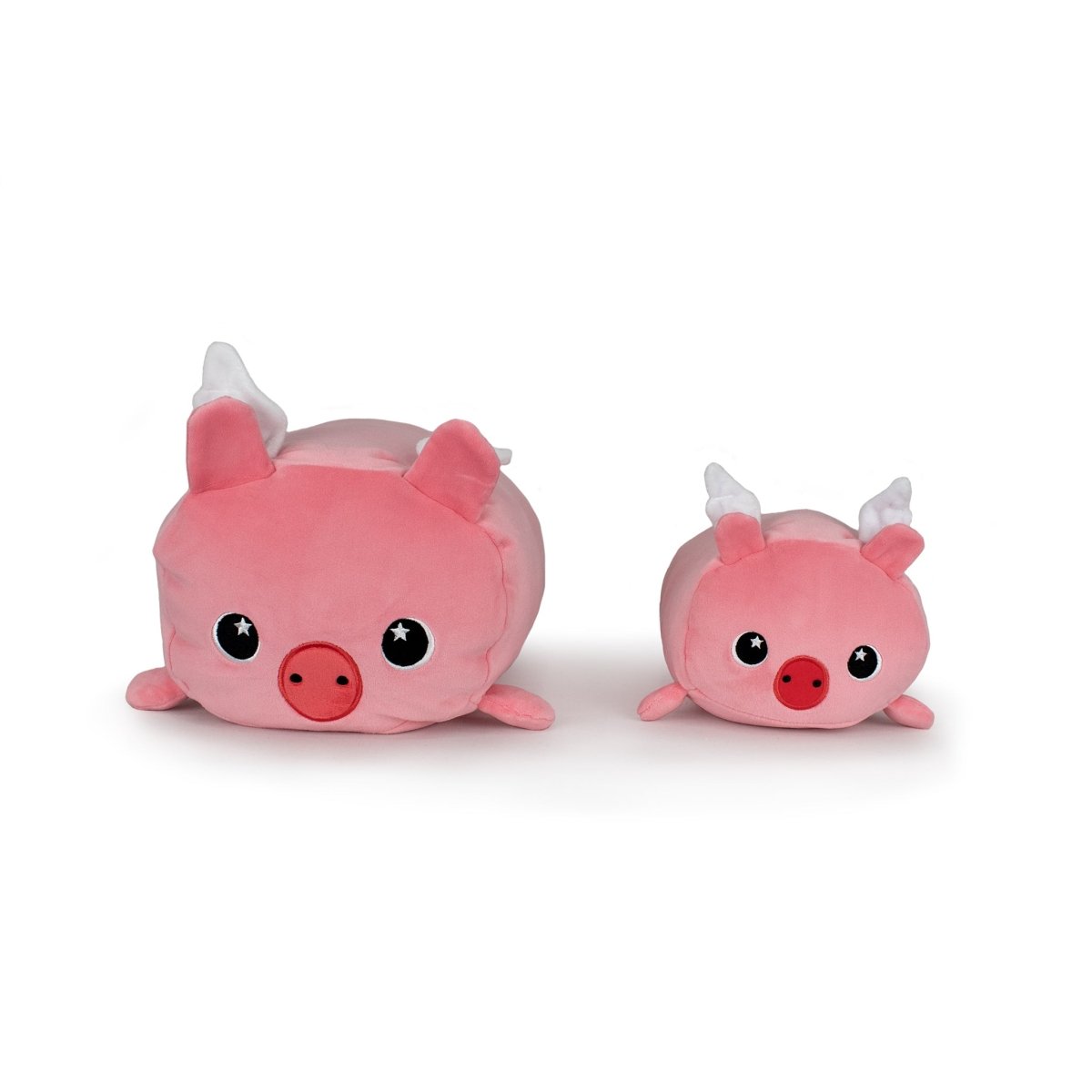Barnaby the Flying Pig plushies, featuring pink bodies, white wings, big round eyes, and small snouts, sit side by side on a white background. The set includes two sizes: one larger Barnaby and one smaller.