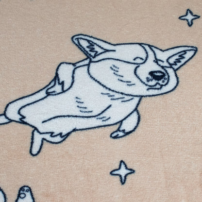 A cartoon of smiling Corey the Corgi lying on its side with closed eyes, surrounded by stars on a light beige background—featured on the super soft 2-in-1 Pillow Blanket.