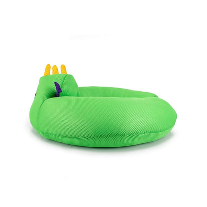 The Drac Crescent 23" Aqua Plush is a round, green, water-friendly cushion shaped like a coiled snake, featuring yellow crown-like spikes on one end and a small purple accent, shown against a white background.