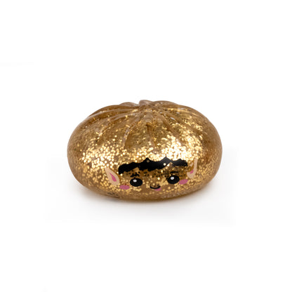 Gold glittery Bubblegum’s Favorite Toy - Holiday Mystery Maltose Dumpling with a cartoon elf face.