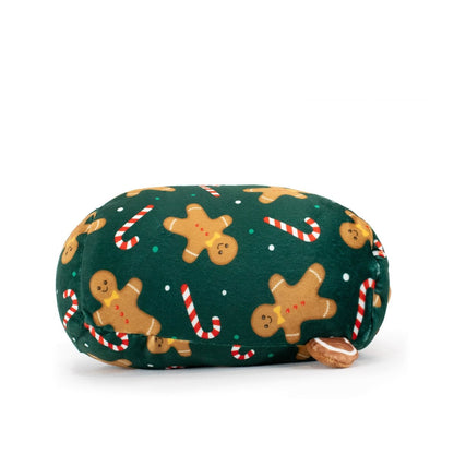 Gingersnaps the Gingerbread Slumber is a cozy, loaf-shaped plush with green fabric featuring gingerbread men and candy canes, plus a cute tail on the right side—ideal for anyone who loves festive holiday stuffed animals.