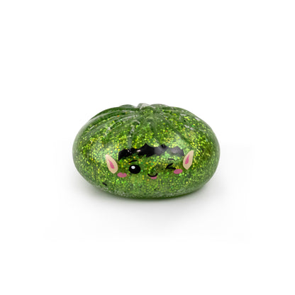 Bubblegum’s Favorite Toy - Holiday Mystery Maltose Dumpling is a green, glittery, squishy dumpling-shaped toy featuring a winking, black-haired elf face.