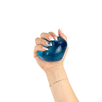 A hand with manicured nails squeezes Bubblegum's Favorite Toy - Solid Sugah-mals Cubes against a white background.