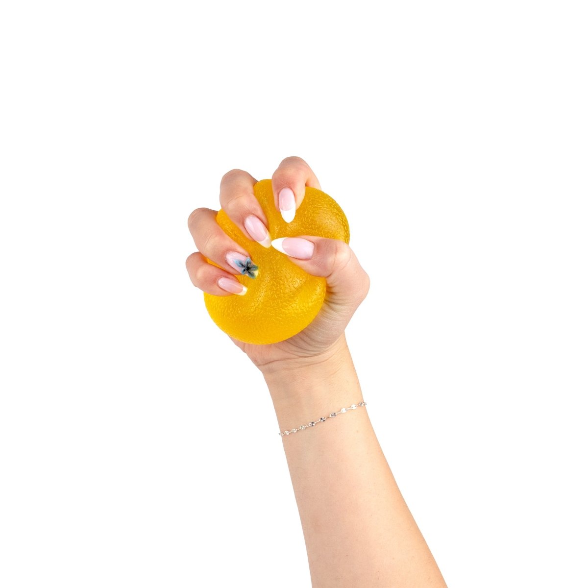 A manicured hand, with a black flower design on one nail, tightly squeezes Bubblegum's Favorite Toy - Sugah-mals Gumdrops stress relief toy against a plain white background.