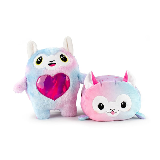 Meet the Daisy and Alpaca Monstah Pair: two pastel rainbow plushies—one stands with big eyes, upright ears, and a shiny heart patch; the other is round with pointy ears, lying down and smiling. Both are sensory soft and machine washable.