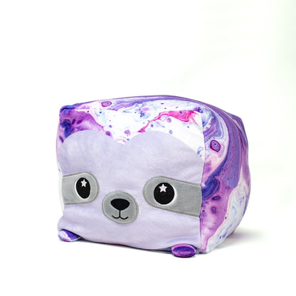 Maybel the Sloth Plushie is an adorable toy with a square body and purple-white swirling colors. Its soft texture and cute face with starry black eyes make it irresistible, against a white background.