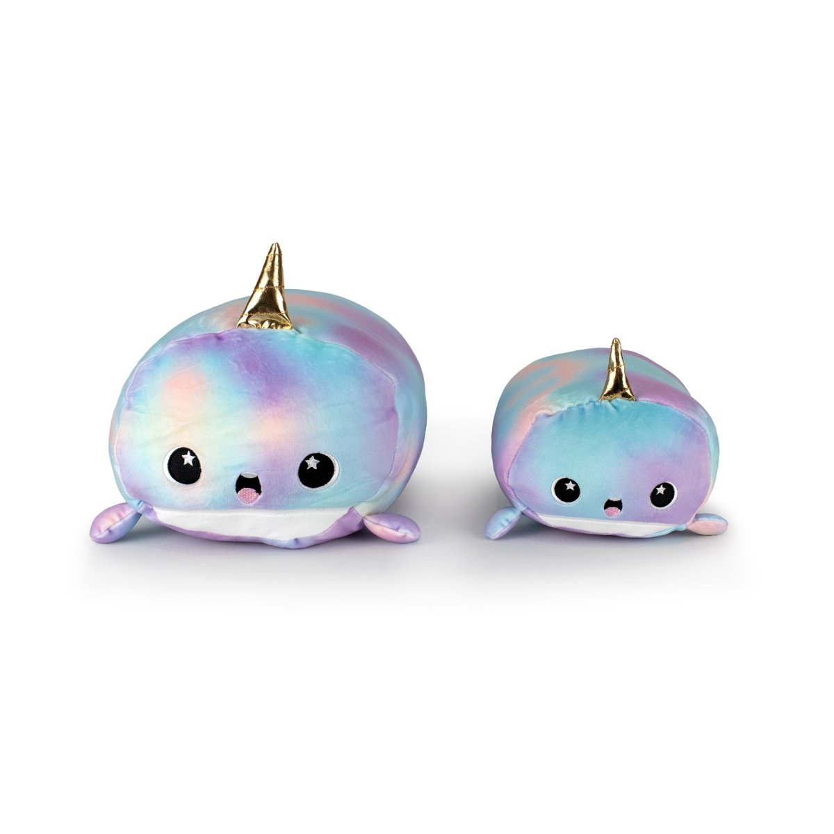Two Tootsie the Narwhal plush toys in pastel rainbow colors with shiny golden horns, big black eyes with star accents, small fins, and happy expressions. The plushie on the left is larger than the one on the right.