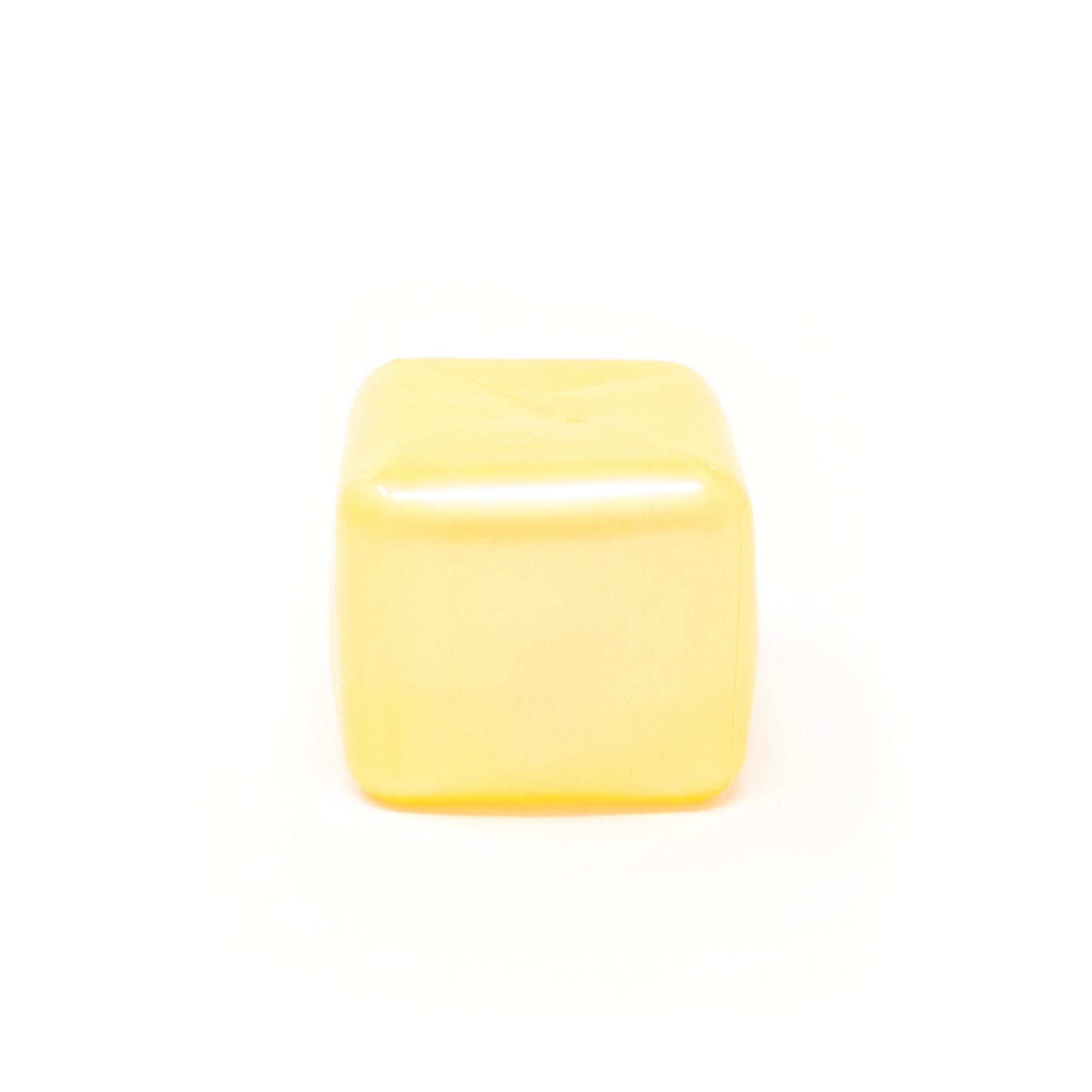 A Sugah-mal Pearl Cube from Bubblegum’s Favorite Toy, smooth, yellow, and translucent, sits on a white background.