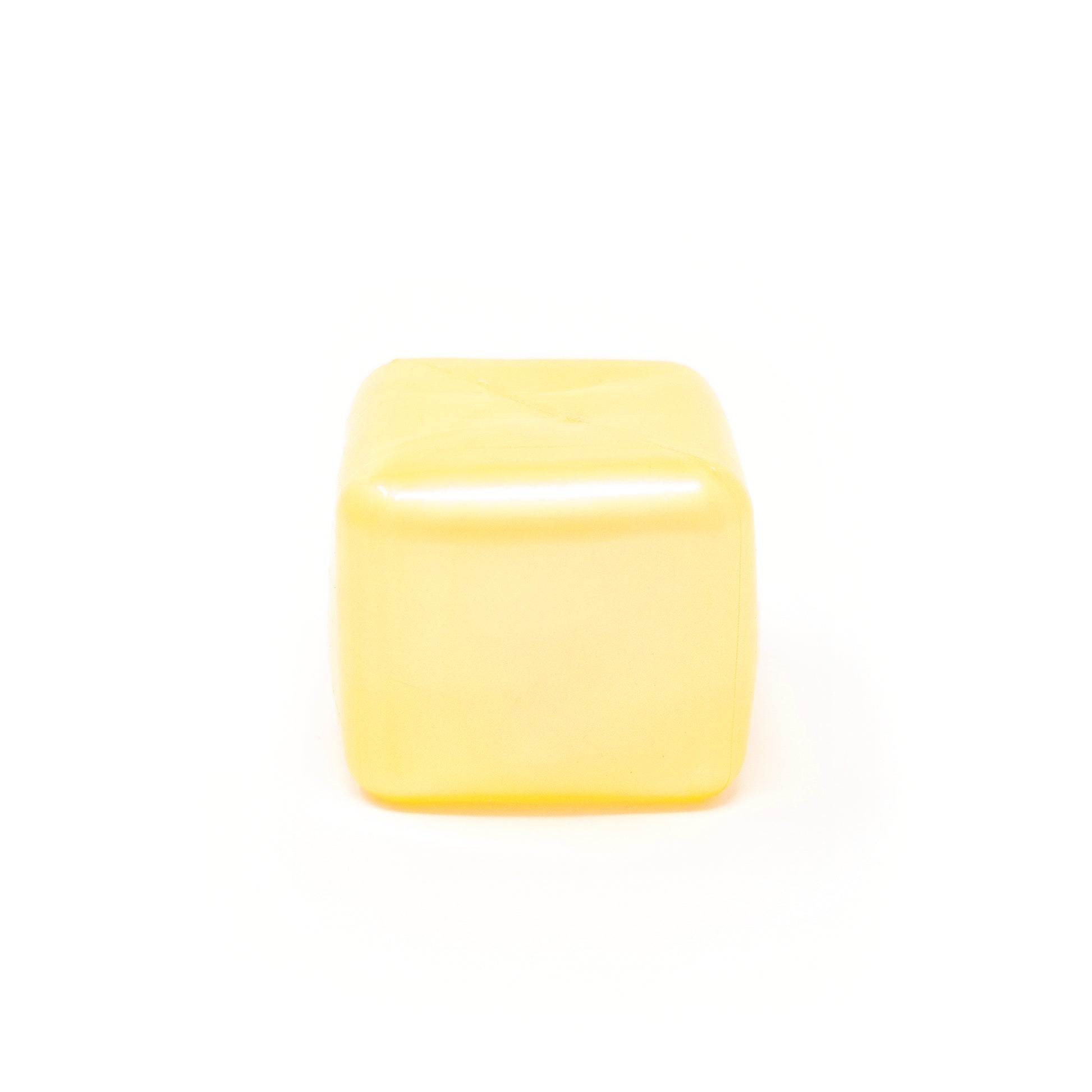 A Sugah-mal Pearl Cube from Bubblegum’s Favorite Toy, smooth, yellow, and translucent, sits on a white background.