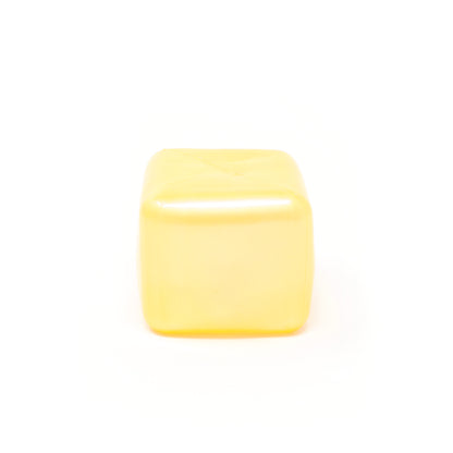 A Sugah-mal Pearl Cube from Bubblegum’s Favorite Toy, smooth, yellow, and translucent, sits on a white background.