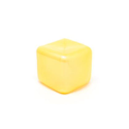 A single Sugah-mal Pearl Cube from Bubblegum’s Favorite Toy—a yellow, translucent, cube-shaped object with rounded edges—sits on a white background.