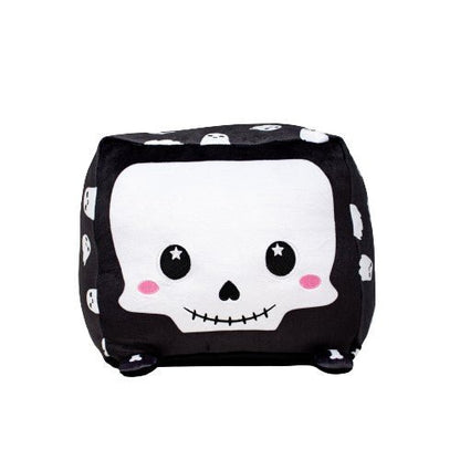Skully the Skeleton is a cute, black cubic stuffed animal featuring a white skull face, rosy cheeks, and star-shaped eyes, with small white skull designs on its sides.