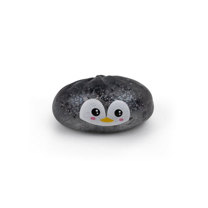 A grey, speckled, dumpling-shaped Bubblegum’s Favorite Toy - Holiday Mystery Maltose Dumpling squishy toy featuring a cartoon penguin face.