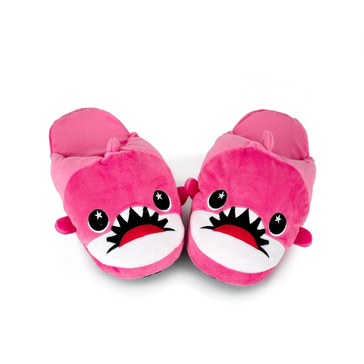 Nibbler the Pink Shark Kids Slippers are bright pink, shaped like cartoon sharks with big eyes and teeth, shown side by side on a white background—perfect plush slippers for cozy fun at home.