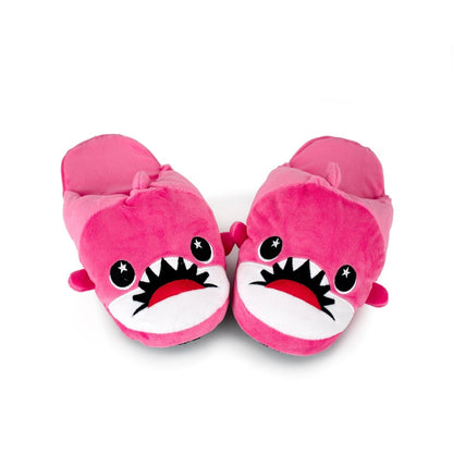 Nibbler the Pink Shark Kids Slippers are bright pink, shaped like cartoon sharks with big eyes and teeth, shown side by side on a white background—perfect plush slippers for cozy fun at home.
