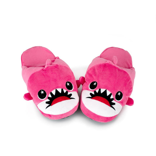 Nibbler the Pink Shark Kids Slippers are bright pink, shaped like cartoon sharks with big eyes and teeth, shown side by side on a white background—perfect plush slippers for cozy fun at home.