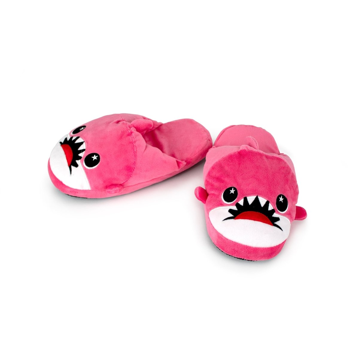 Nibbler the Pink Shark Kids Slipper: pink plush house slippers shaped like sharks with cartoon faces, big eyes, open mouths showing teeth, and non-slip soles for kids.