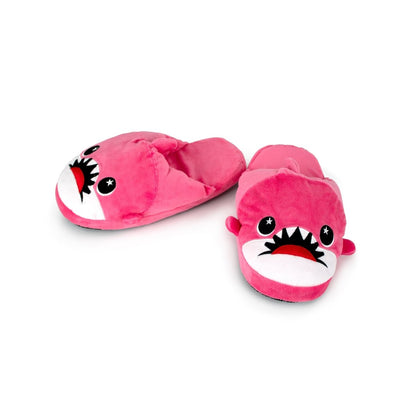 Nibbler the Pink Shark Kids Slipper: pink plush house slippers shaped like sharks with cartoon faces, big eyes, open mouths showing teeth, and non-slip soles for kids.
