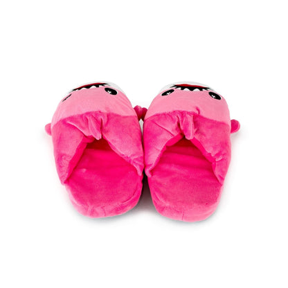 Nibbler the Pink Shark Kids Slipper features bright pink plush slippers designed as cartoon sharks with open mouths, white teeth, and big eyes, shown side by side on a white background.