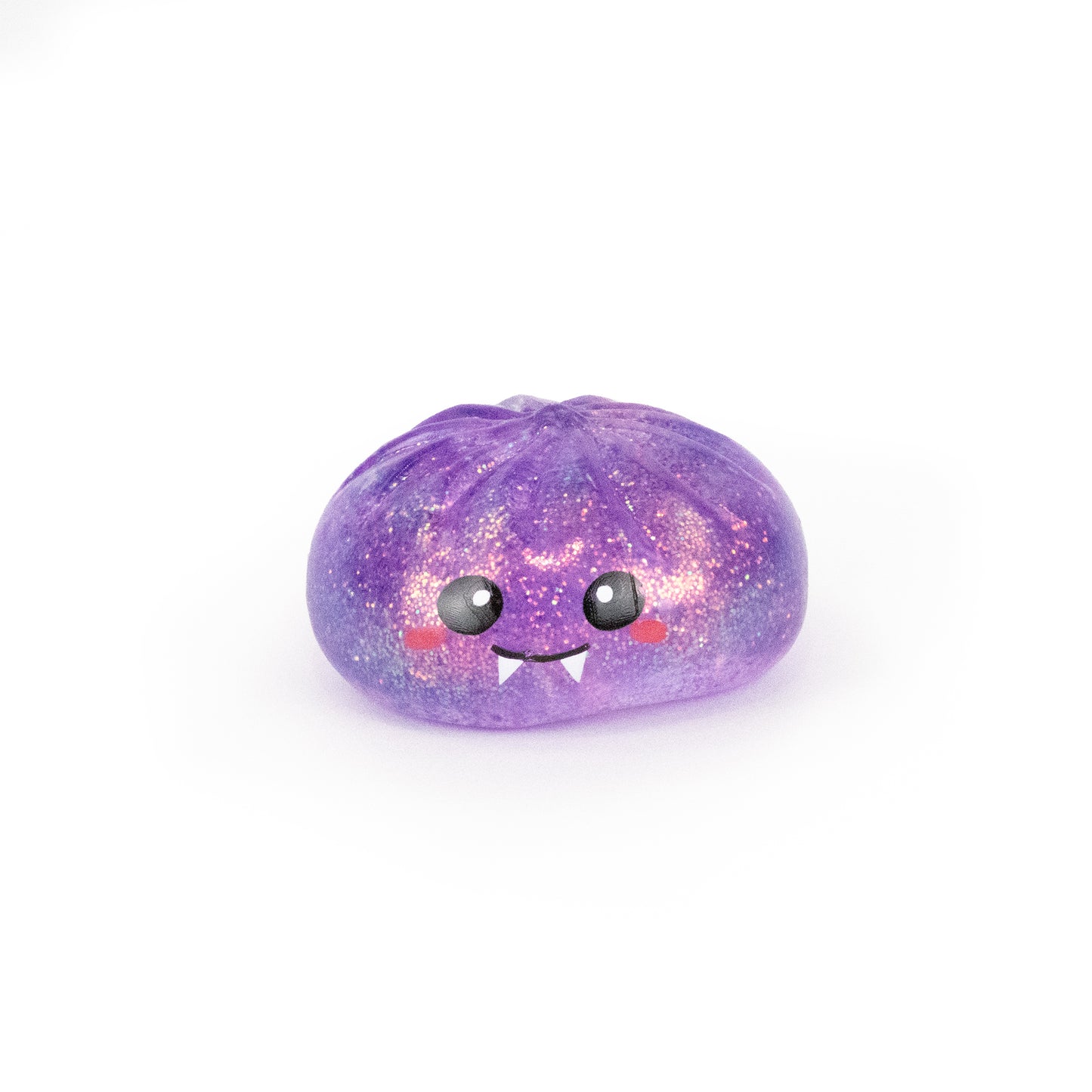 A tiny, purple, glittery Spooky Mystery Dumpling from Bubblegum’s Favorite Toy collection, featuring a cute smiling face with big eyes, blushing cheeks, and little fangs, set against a white background.