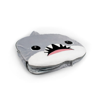 The 2-in-1 Pillow Blanket - Crush the Shark is a plush, gray shark-shaped pillow featuring a cute face, wide eyes, felt teeth, and a pink tongue, shown on a white background.