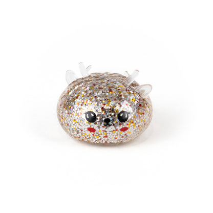 A round, clear, glitter-filled Bubblegum’s Favorite Toy - Jr Reindeer Mystery Maltose Dumpling with black eyes and red cheeks.