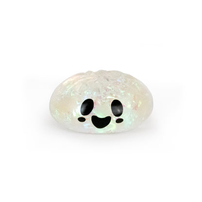 Bubblegum’s Favorite Toy - Spooky Mystery Dumpling is a small, translucent, glittery dumpling with a smiling cartoon face, big black eyes, and an open mouth, displayed on a white background.